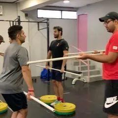 Our Olympic Weightlifting seminars start from the absolute basics. Here you can see a coach guiding athletes through fundamental positions using PVC pipes, focusing on mobility and technique before adding any weight.