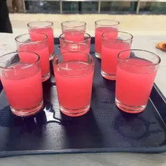 A tray of pink welcome drinks ready to be served at a naming ceremony in Airoli.