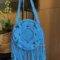 Our round macramé sling bag in a beautiful sky blue. This boho-chic bag features an intricate mandala pattern and long fringe, making it a standout accessory for any outfit.