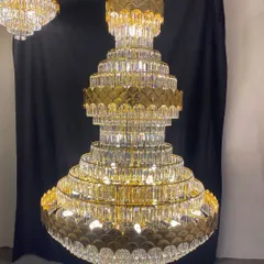 A magnificent, tiered crystal chandelier designed for large spaces like hotel lobbies or grand villas. The combination of gold metalwork and cascading crystals creates an unforgettable impression of luxury and scale.
