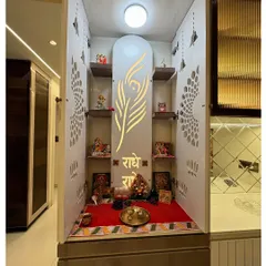 This pooja unit features a 'Radhe Radhe' inscription and a peacock feather motif on its backlit panel. The design is both divine and artistic, creating a peaceful corner for prayer.