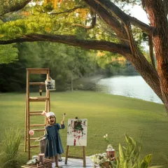Childhood is a canvas, and every child is an artist painting their own story. For this creative outdoor milestone shoot, we set up an easel by the water, letting her imagination run free. It’s about celebrating her unique spirit in a world built just for her.