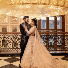 For couples who envision pure opulence, I find locations that match their dream. Here, the grandeur of the hall, with its magnificent chandelier and classic decor, provides a regal backdrop for this elegant pre-wedding portrait.