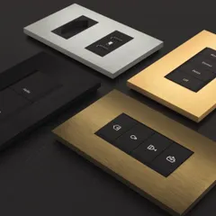 A stunning collection of Roehn keypads in various finishes, including brushed metal and gold. These minimalist designs offer powerful scene control while disappearing into your walls.
