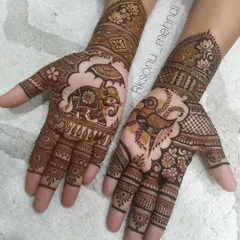 This design focuses on large, prominent figures. One hand features a decorated royal elephant, while the other showcases a magnificent peacock, both classic symbols of beauty and grace in mehndi.