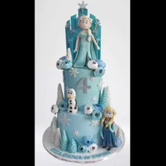 A three-tier Frozen-themed cake featuring Elsa, Anna, and Olaf. This detailed whipped cream creation is perfect for a winter wonderland party, complete with edible snowflakes and frosted trees.