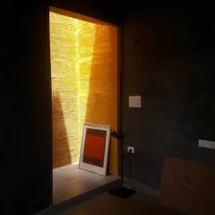 In our Ghitorni studio, a narrow skylight washes a rammed earth wall with intense yellow light, creating a stark contrast with the dark, textured interior. The effect is a tribute to the artist Rothko.
