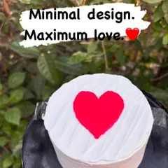 Minimal design, maximum love. This simple round cake features a clean, textured white buttercream and a single, bold red heart in the center, proving that simplicity can be stunning.