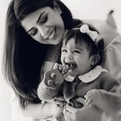 A beautiful, emotional black and white portrait of a mother and her laughing baby. A timeless keepsake.