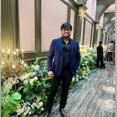 At a wedding venue, ready to direct the evening's festivities. I see myself as a wedding maker, ensuring the entertainment is as grand as the decor.