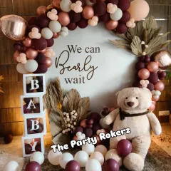 A modern and chic "We Can Bearly Wait" themed baby shower. We used a sophisticated color palette of maroon, beige, and rose gold balloons, with a large teddy bear and pampas grass for a warm, bohemian feel.