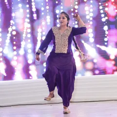 A powerful Bhangra pose captured on stage. This folk dance is all about strength, energy, and celebrating with every step.
