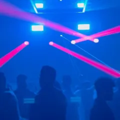 A snapshot of the laser light show in action. I program and control the lighting to sweep over the crowd, adding another layer of energy to the club experience.