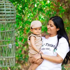 A sweet mother and son portrait taken during an outdoor photoshoot. The lush green background adds a fresh and vibrant feel to this loving picture.