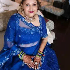 A beautiful look for the mother of the groom, featuring defined eyes, a bold lip, and traditional jewelry. The makeup enhances her features, making her look regal and ready for the wedding ceremony.