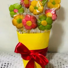 A unique and charming gift idea, this is my flower cookie bouquet. I bake and decorate colorful flower-shaped cookies and arrange them in a pot with a ribbon, creating a beautiful and edible centerpiece.