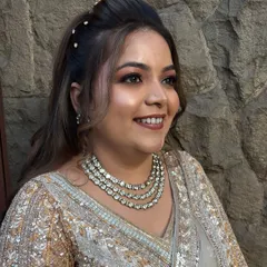 A beautiful candid shot of a reception bride. Her makeup features a soft smokey eye and a nude lip, paired with a stunning diamond necklace.