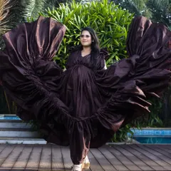 This flowing brown taffeta gown creates a stunning silhouette, especially when tossed for a dramatic effect. It's a versatile piece that works beautifully for both poolside and beach maternity shoots.