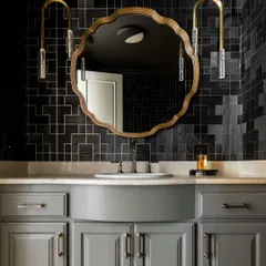 This atmospheric powder room showcases the 'Fretwork' collection from Phillip Jeffries in a bold charcoal shade. The elaborate geometric pattern adds depth and sophistication, turning a small space into a dramatic design moment.