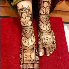 A unique foot design featuring Warli art style figures, combined with traditional elephant and palace motifs for a fusion look.