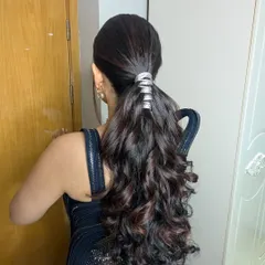 The hairstyle for a glamorous cocktail night. This sleek, high ponytail with a metallic wrap is modern, edgy, and guaranteed to stay in place while you dance the night away.