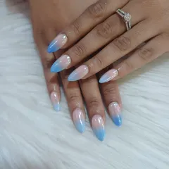 A beautiful and clean look featuring a seamless ombre blend from a natural nude base to a soft sky blue. These almond-shaped gel extensions are perfect for an elegant, everyday style with a pop of color.
