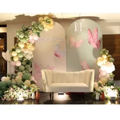 Another view of the butterfly-themed 'Baby in Bloom' setup, highlighting the delicate printed backdrops and the soft, ethereal color palette.