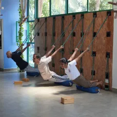 Students in our Kurunta workshop using ropes and bolsters to find length and release in their spines. The ropes provide unique support that allows the body to open up in ways that are not possible on the mat alone.