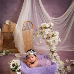 Dreaming in a field of lavender. The purple and white floral arrangement, combined with the sheer curtains, creates a beautiful, ethereal, and royal setting.