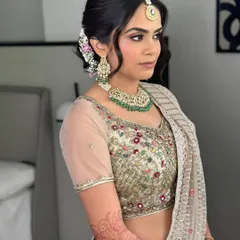 A side view showing the soft waves in her hair and the delicate makeup. This look was meant to turn heads with its understated perfection.