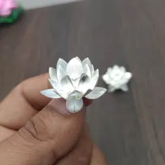 A pair of German silver flowers. These never-fading flowers can be offered to deities during pooja and used again and again.