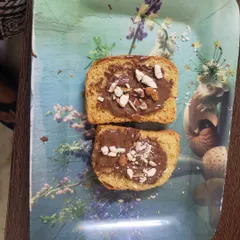 The finished product. A delicious chocolate rusk topped with nuts and sprinkles, made entirely by the student. This gives them a wonderful sense of accomplishment.