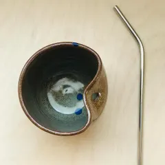 Introducing the "Sip Buddy," a sippable ceramic cup with a dedicated slot for your reusable straw. This one features an earthy glaze with playful blue polka dots.