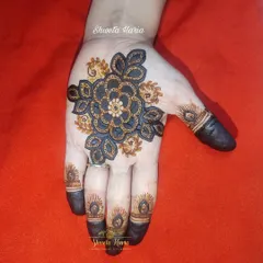 A simple yet striking floral mandala on the palm, using a dual-tone technique to create a bold, 3D effect.