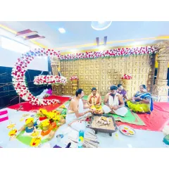 The sacred pooja taking place in front of the crescent moon floral arrangement. It's an honor to create the backdrop for such an important family ritual.