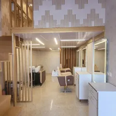 Our salon interior features a clean, contemporary design with professional hair washing stations and well-equipped styling areas, creating a serene and professional atmosphere.