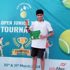 Rudra Pandey, a recent joiner, holding his first-ever title trophy from an Open Junior U12 tournament. This shows how our foundational training at the Dwarka center helps build champions quickly.