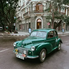 A beautifully maintained vintage green Morris Minor on the streets of South Bombay. Capturing these classic cars feels like stepping back in time.