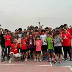 Coach Toni poses with our athletes. These multicultural exchanges are part of our commitment to giving our players a global perspective on the game and its culture.