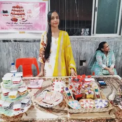 A photo of me at the 'Be A Hunarmand' exhibition. I feel so proud and thankful to be able to stand behind my table, which is filled with all the chocolates and desserts I made myself.