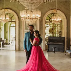 For a touch of royal elegance, this magenta trail gown is a favorite for pre-wedding shoots. Its long, flowing train spreads out beautifully against the grand backdrop of this palace hall, creating a truly cinematic and romantic photograph.