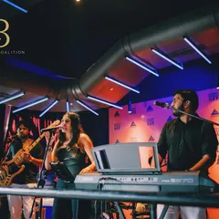 On stage performing for an Embassy corporate event. Our dual lead vocalists, Shanelle and Aryaman, engage the crowd while the band lays down a solid groove.