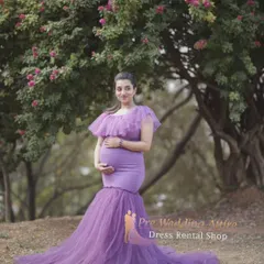 The lavender mermaid gown looks ethereal in a natural, wooded setting. The soft purple color and delicate tulle create a dreamy atmosphere for your maternity portraits.