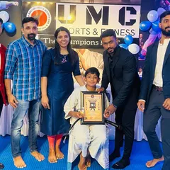 A young student, supported by his proud family, receives his black belt certificate. We believe in celebrating these huge achievements with the families who provide unwavering support along the way.