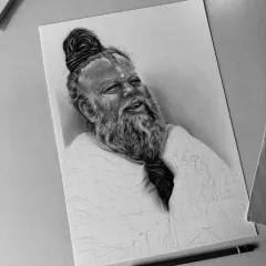 A work in progress. You can see how the portrait slowly emerges from the paper, with the face and beard almost complete.