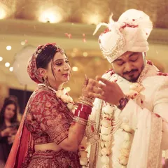 A playful and candid moment during the varmala ceremony, capturing the fun and games that are part of the tradition.