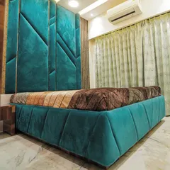 I believe your bedroom should have a personality. This master bedroom features a bold, geometric headboard in a rich teal velvet, creating a space that feels both luxurious and uniquely different.