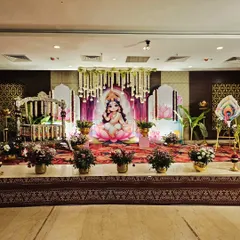 This beautiful cradle ceremony was designed to welcome a baby girl with a 'Baby Lakshmi' theme. The stage features a custom printed backdrop of the goddess, elegant floral arrangements, and a traditionally decorated swing.