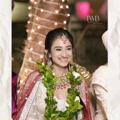 A candid moment of pure joy during the wedding ceremony. The bride's happy, natural smile as she participates in the rituals is a memory to be cherished forever.