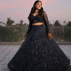 This bride is ready to steal the spotlight at her sangeet. The look features a fierce blue shimmer wing, a flawless glow, and a modern hairstyle with cascading waves.